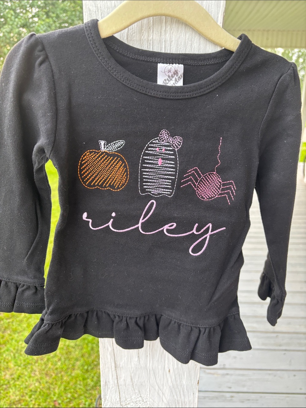 Riley Black Long-Sleeve Ruffle Hem Top with Halloween Motif